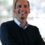 A smiling person in an office setting, related to South Metro Atlanta cosmetic dentistry services.